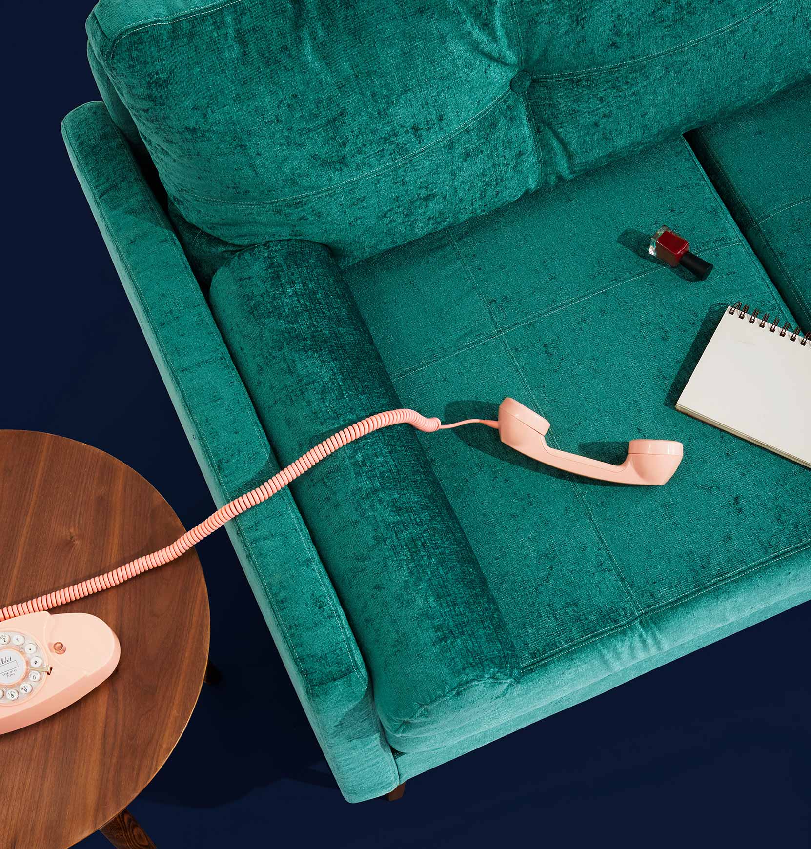 Phone and Notebook on Green Couch Phone and Notebook on Green Couch